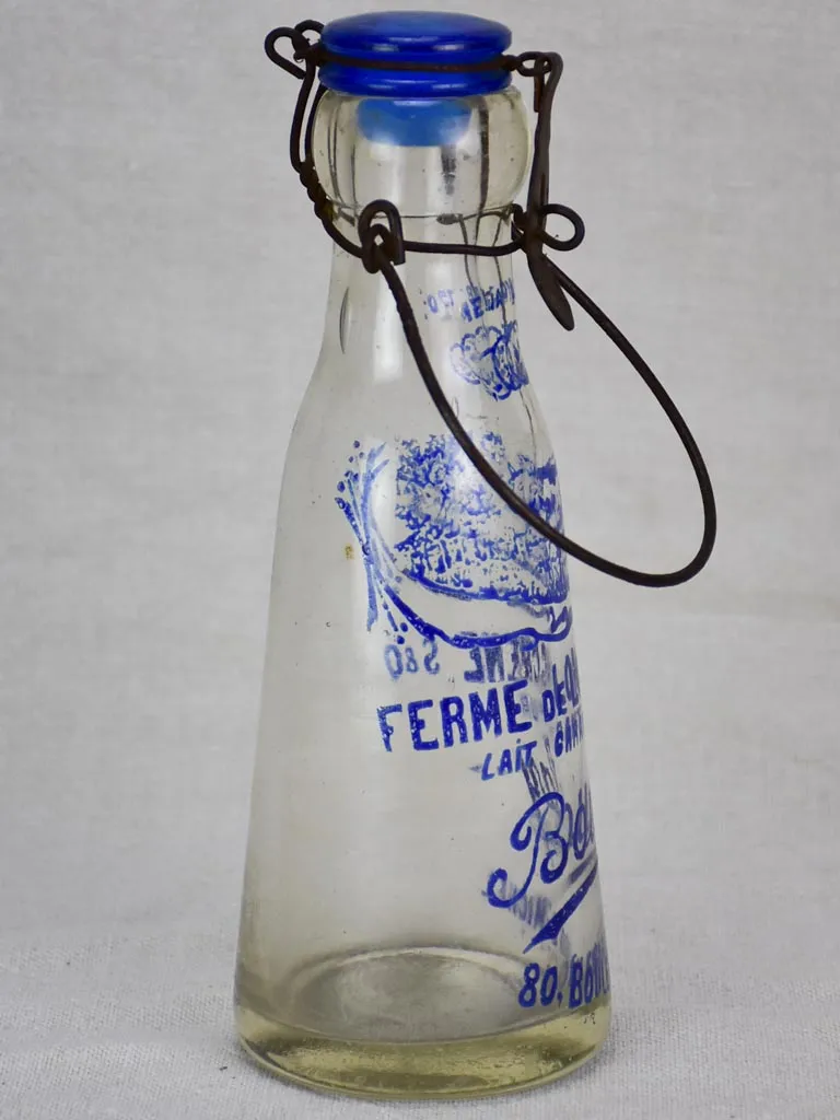 Antique French glass milk bottle with blue decoration